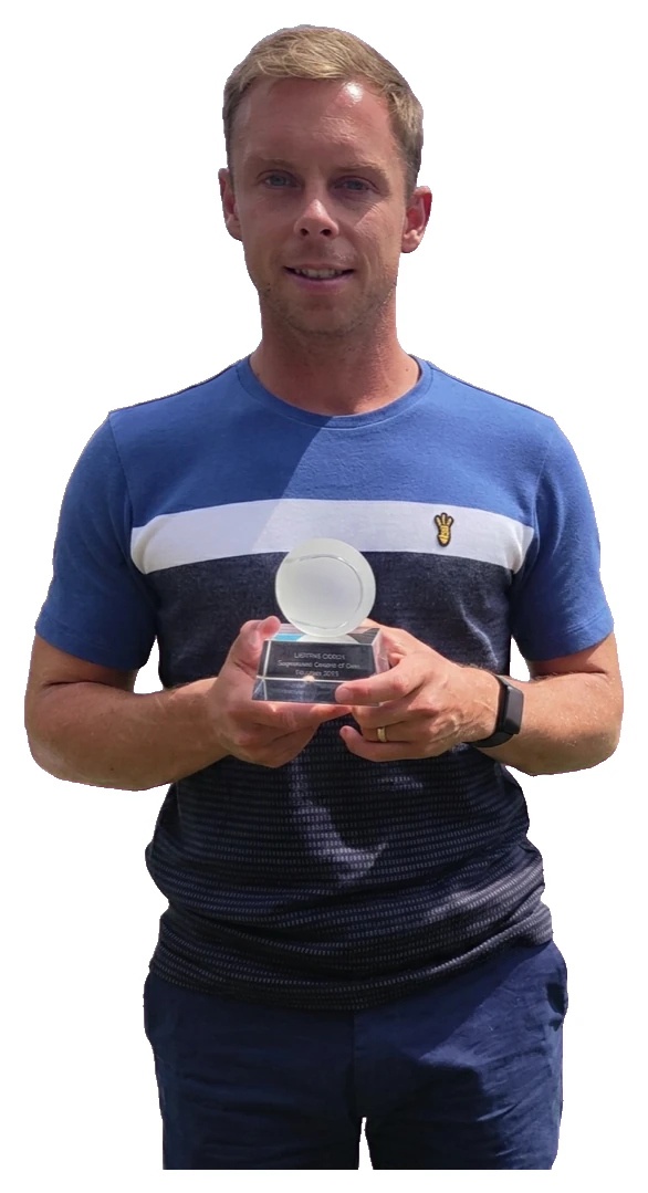 Edd, founder of The Rally Hub, holding his LTA Tennis Awards Coach of the Year trophy